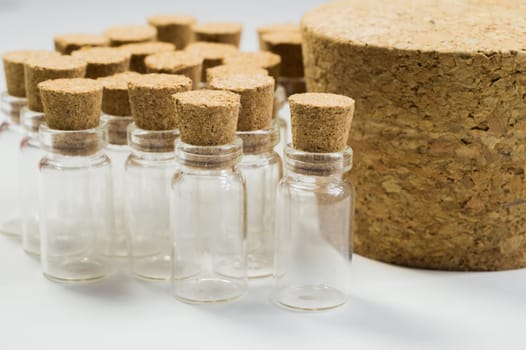 Empty little bottles with cork stopper isolated on white. glass vessels. transparent containers. test tubes. big cork