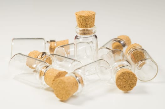 Empty little bottles with cork stopper isolated on white. glass vessels. transparent containers. test tubes
