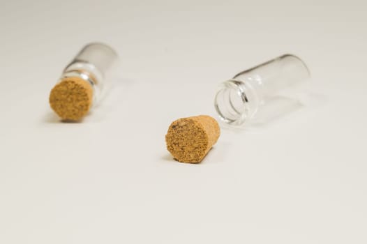 Empty little bottles with cork stopper isolated on white. glass vessels. transparent containers. test tubes