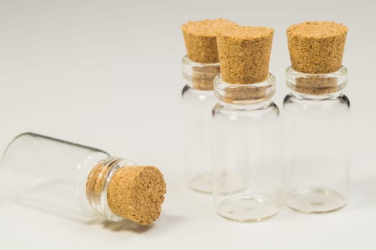 Empty little bottles with cork stopper isolated on white. glass vessels. transparent containers. test tubes