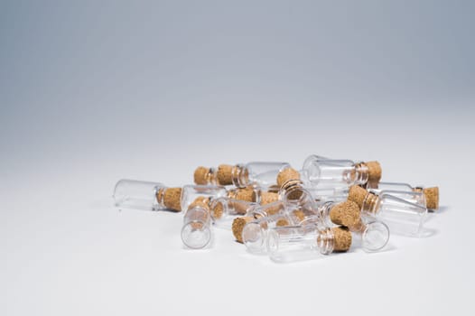 Empty little bottles with cork stopper isolated on white