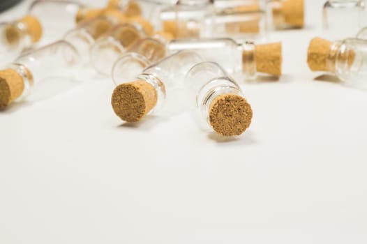 Empty little bottles with cork stopper isolated on white. glass vessels. transparent containers. test tubes. copy space