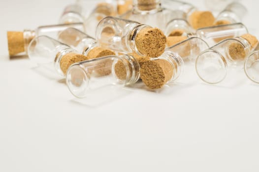 Empty little bottles with cork stopper isolated on white. glass vessels. transparent containers. test tubes. copy space