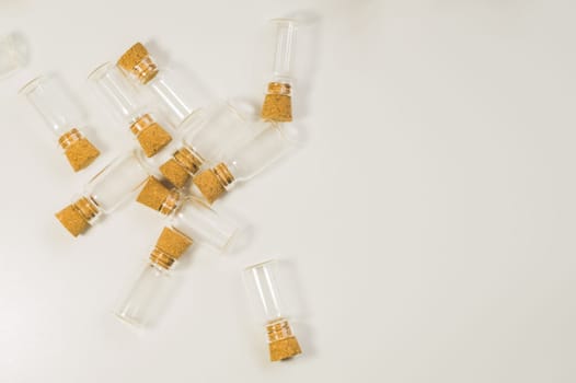 Empty little bottles with cork stopper isolated on white. glass vessels. transparent containers. test tubes. copy space