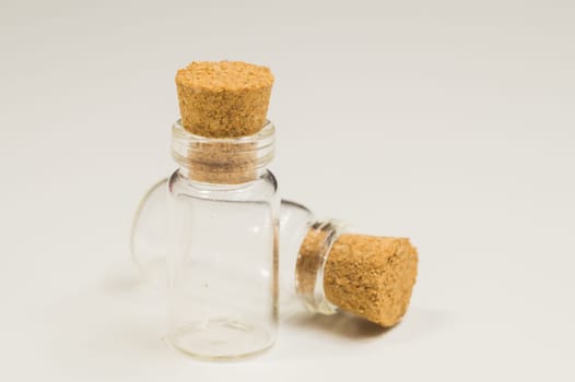 Empty little bottles with cork stopper isolated on white. glass vessels. transparent containers. test tubes