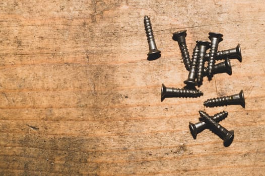 Screws on a wooden background.working tools. copy space