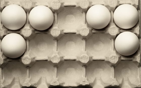 White eggs in carton box background. food ingredient. protein nutrition. healthy breakfast. poultry egg