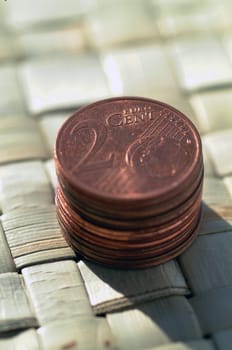 euro coins on a wicker mat