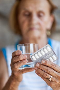 Senior woman taking her daily prescripted medication