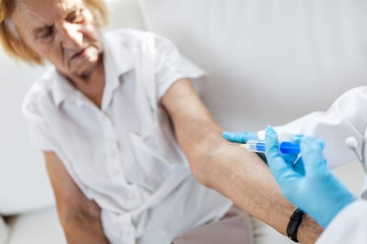 Doctor administering a vaccine on an elderly patient