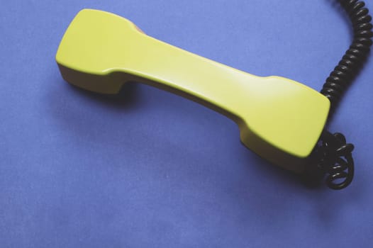 Telephone handset. phone receiver on blue background. old communication technology. copy space