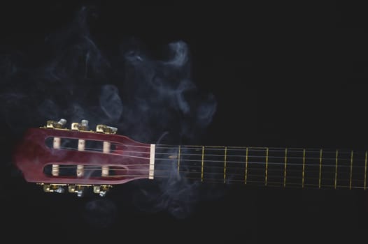 Guitar headstock on black background. acoustic musical instrument. copy space