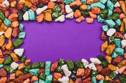 Candy pebbles. sweets in the form of colored stones. frame made from colorful candies
