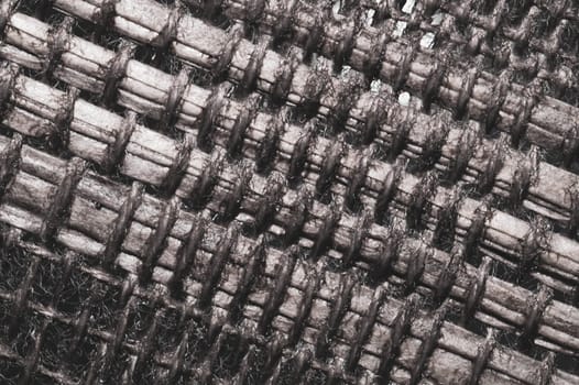 Braided fibers close up. woven texture. wicker background. knitted surface. weaving pattern. stitches of thread