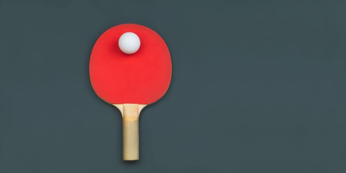 Red table tennis racket with a ball isolated on a colored background. sport equipment for ping pong. copy space