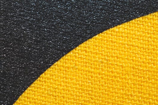 Black and yellow fabric texture. knitted textile close up. woven background macro