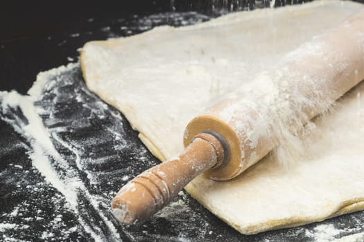 Dough with rolling pin and flour. homemade pizza base preparing