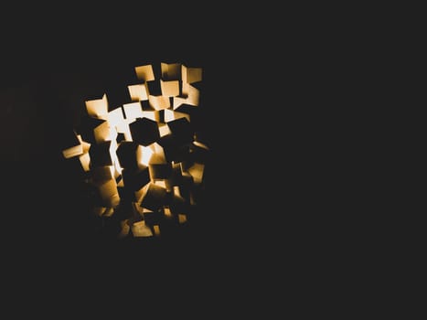 Wooden cubes stack with light shines in the dark. abstract structure with squared blocks