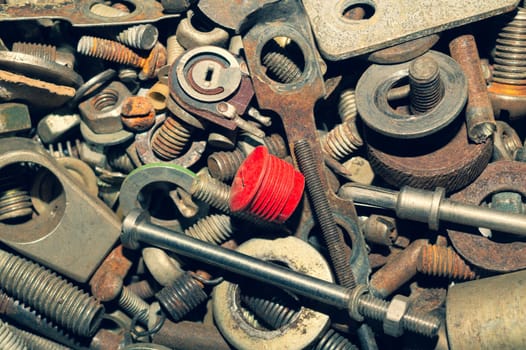 Pile of fasteners and screws close up. scrap metal. different metal parts