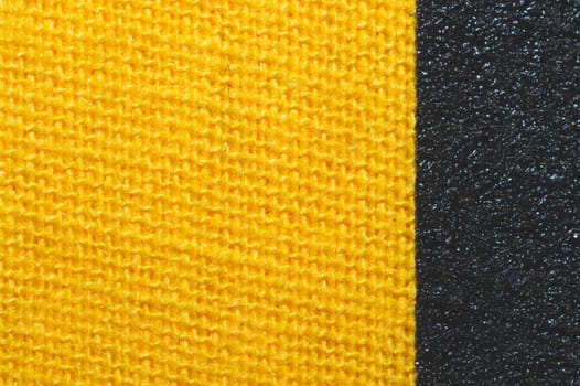 Black and yellow fabric texture. knitted textile close up. woven background macro