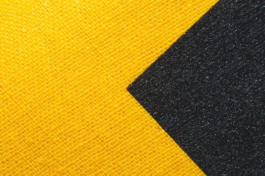 Black and yellow fabric texture. knitted textile close up. woven background macro