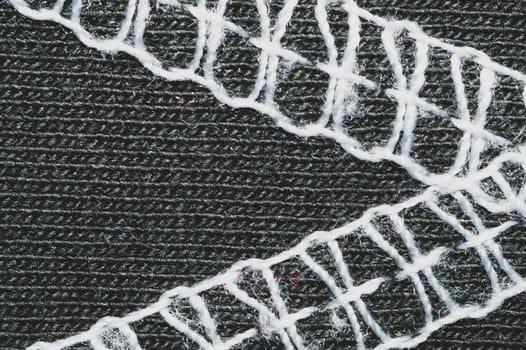 White seams on black fabric. stitches on textile material close up