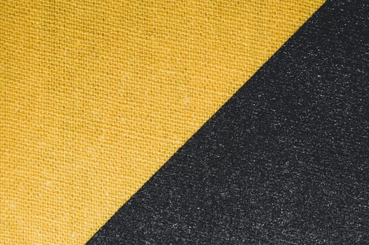 Black and yellow fabric texture. knitted textile close up. woven background macro
