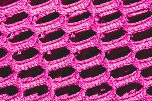 Pink fabric texture macro. abstract knitted pattern. woven material. textile background