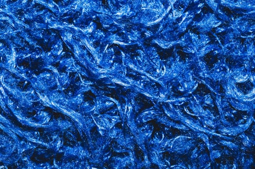 Soft fabric texture. blue textile with curly fibers. wool background close up