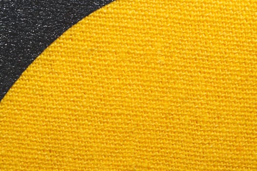 Black and yellow fabric texture. knitted textile close up. woven background macro