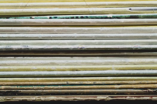 Stack of old magazines. pile of retro newspapers. vintage journals lie on top of each other