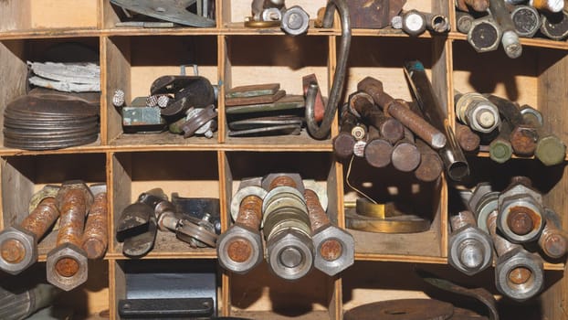 Metal bolts and nuts in the work shelf. various fasteners. rusty details in workshop