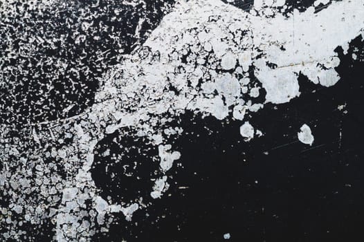 Black steel plate with white paint spots. metal surface with paint splashes. grunge texture. iron background