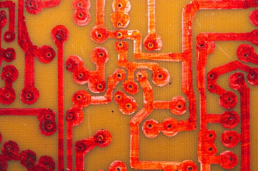 Handmade circuit board with red soldered tracks. industrial background. textolite with soldering
