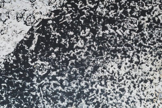 Black steel plate with white paint spots. metal surface with paint splashes. grunge texture. iron background