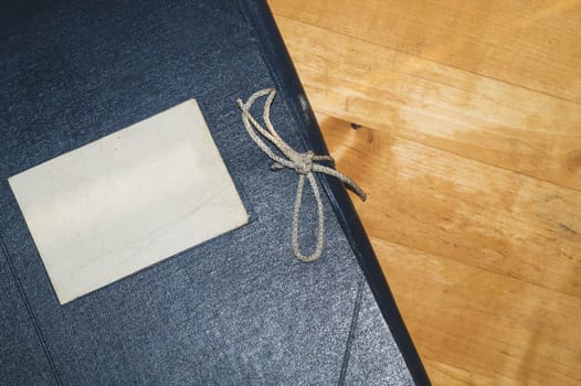 Vintage folder for paper with blank label. old folder for documents lies on a wooden table. copy space
