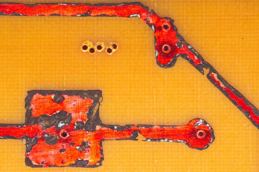 Handmade circuit board with red soldered tracks. industrial background. textolite with soldering