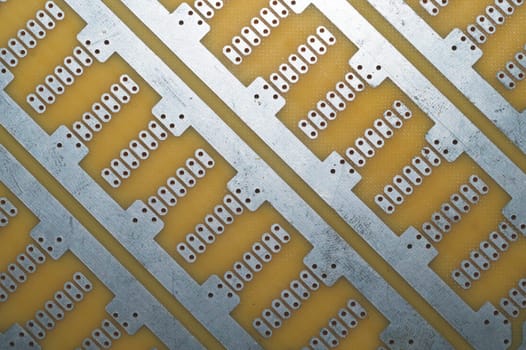 Printed circuit board without elements. textolite surface. template for soldering the circuit. perforated background