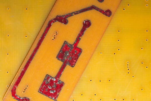 Handmade circuit board with red soldered tracks. industrial background. textolite with soldering