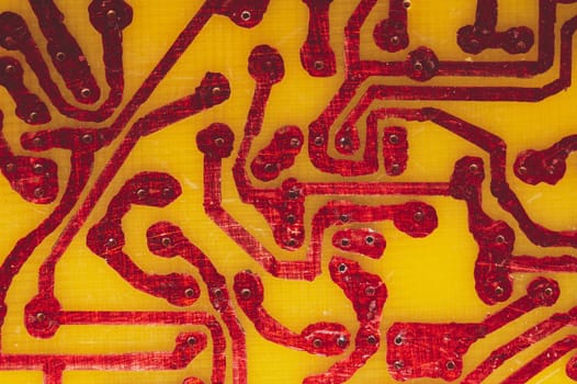 Handmade circuit board with red soldered tracks. industrial background. textolite with soldering
