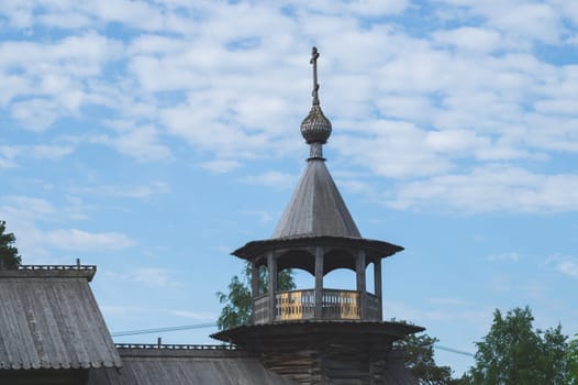 Roof of old wooden church with a cross. traditional architecture