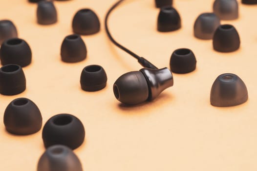 Earphones between of ear cushions. in-ear headphones with many embouchures. audio equipment