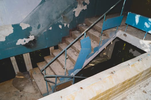 Staircase in an abandoned building. destroyed house