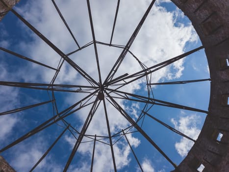 View of the sky through a ruined roof construction. steel carcass for roof mounting