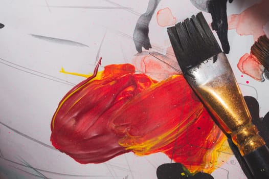 Paintbrush close up. drawing process. paint spots on the paper