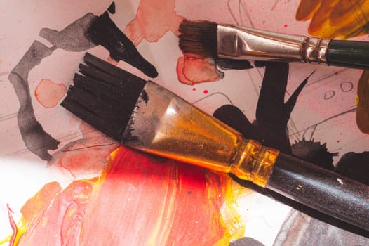 Paintbrush close up. drawing process. paint spots on the paper