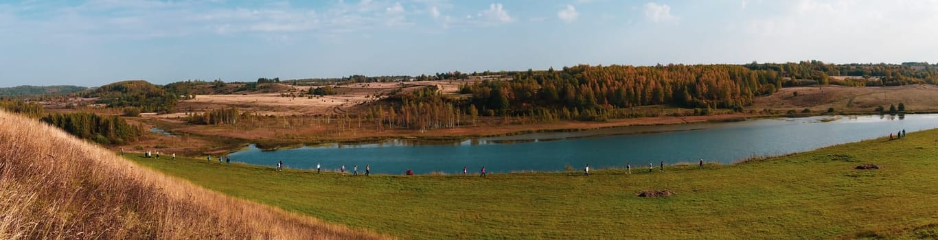 Pilgrims walk along the lake in the valley. nature landscape panorama aerial view