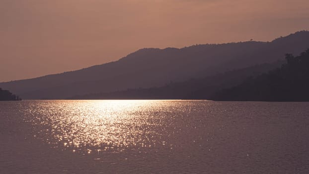 Mountain lake with perfect reflection at sunrise. beautiful landscape with glitter light  reflected in water. Nature lake landscape
