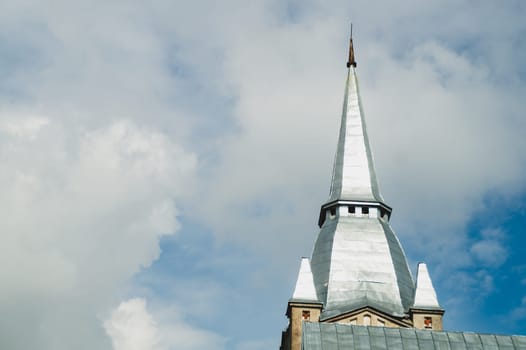 Spire of the lutheran church against the cloudy sky