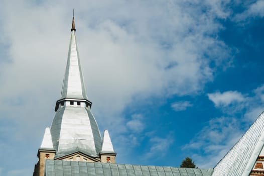 Spire of the lutheran church against the cloudy sky
